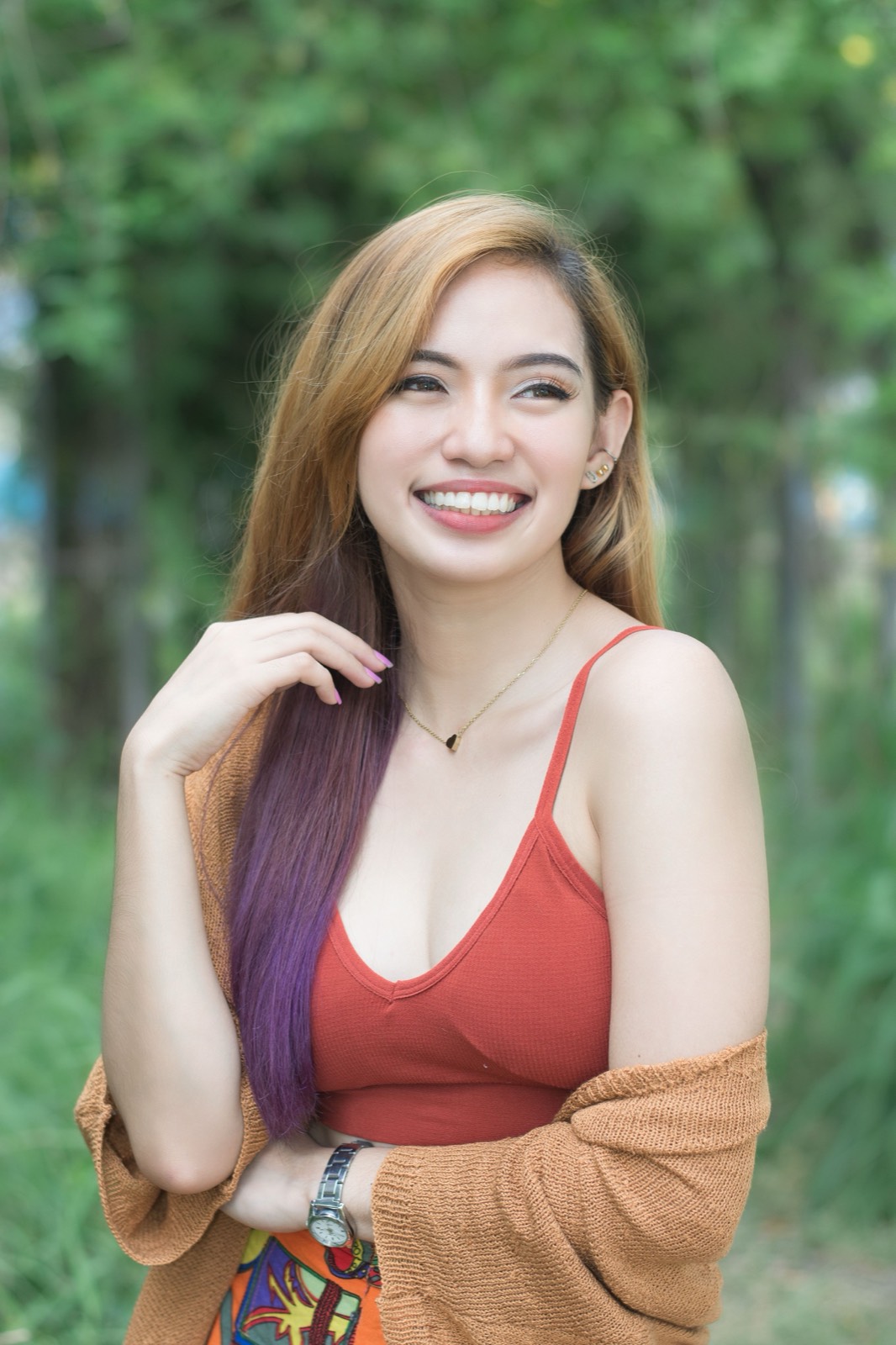 Illustrative photo of a smiling Filipina woman outdoors